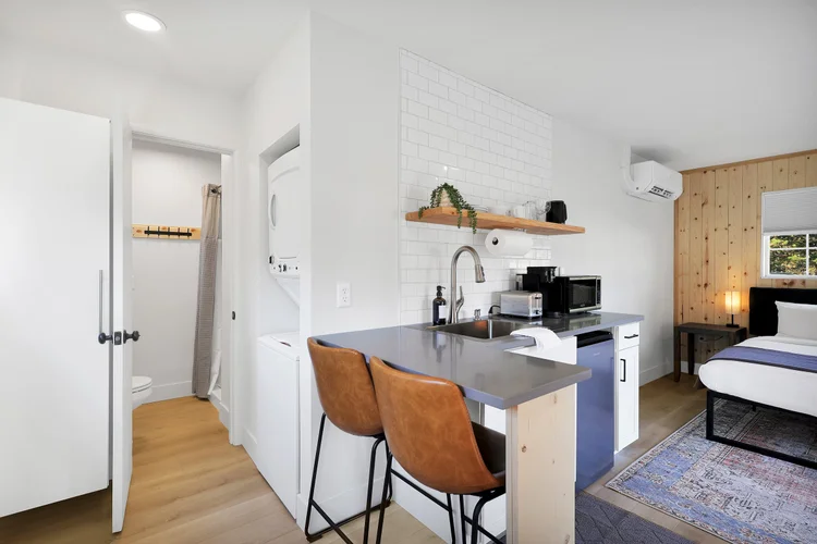 The cabin's own kitchen counter, seating, and private bath