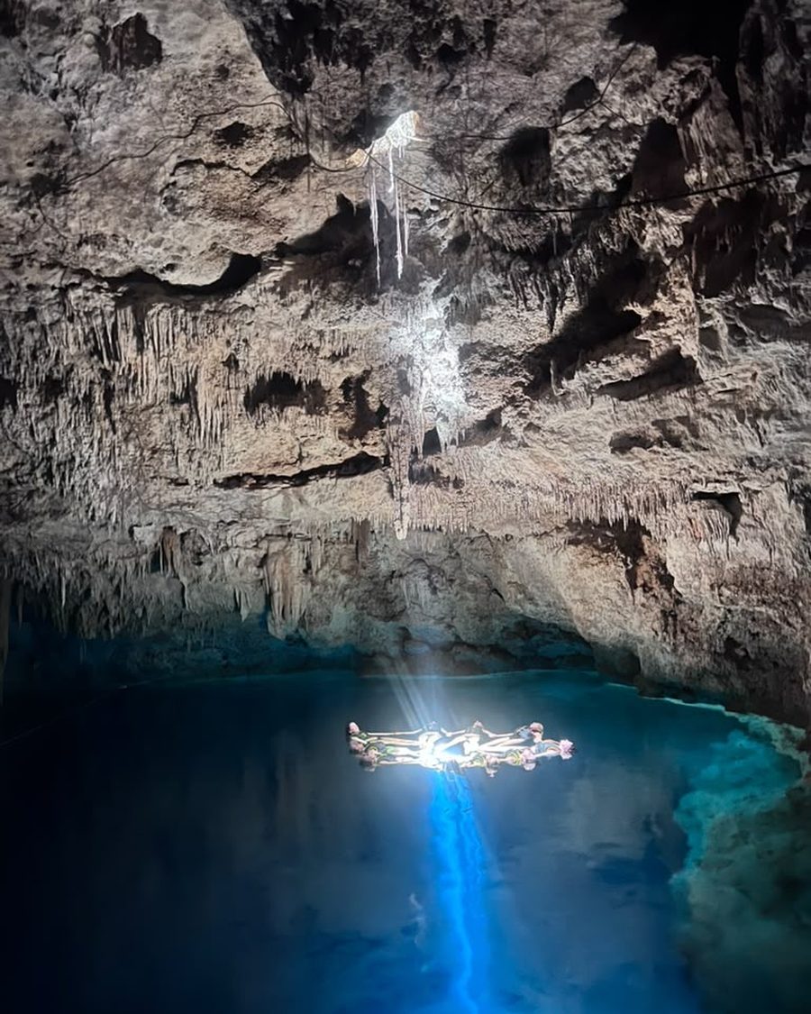 Sisters floating in a circle in the cenote cave